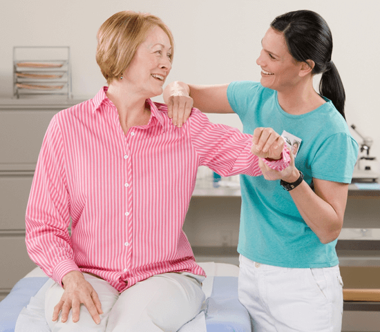 Photo of a physical therapist helping a fibromyalgia patient.